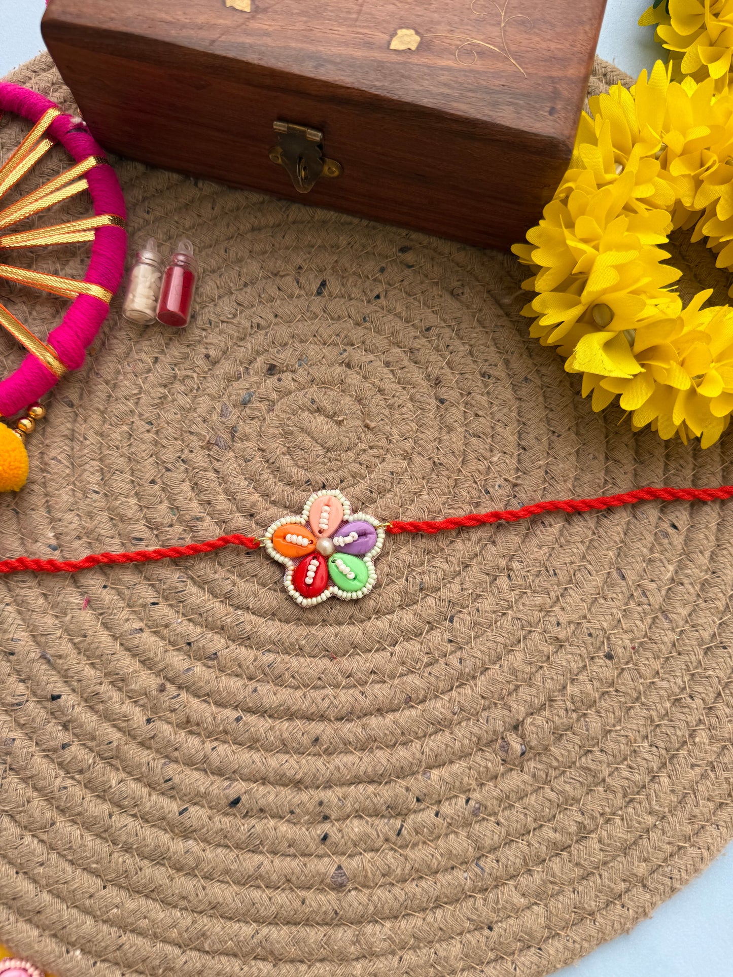 Flowers cowrie Rakhi by elegantstyle