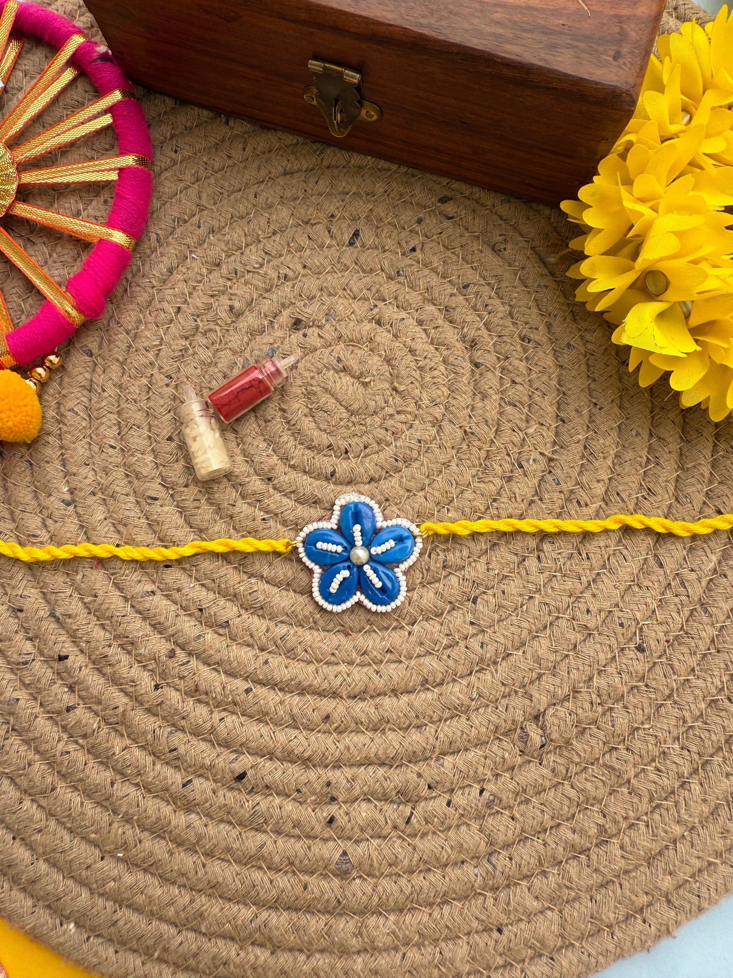 Flowers cowrie Rakhi by elegantstyle